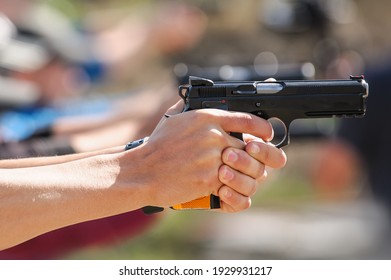 Close up of young hand on tactical gun training classes. Shooting and Weapons. Outdoor Shooting Range
