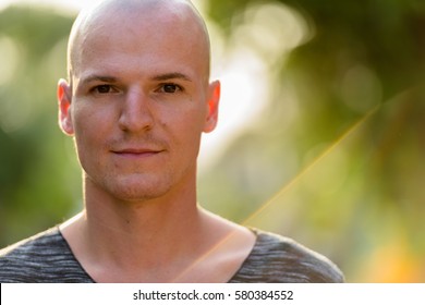 Close Up Of Young Handsome Bald Man Outdoors