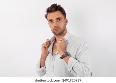 Close up of a young handsome bearded man in white shirt against a white background - Powered by Shutterstock