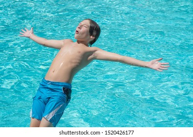 Close Of A Young Handsome Boy Falling Backwards Into A Pool Of Water