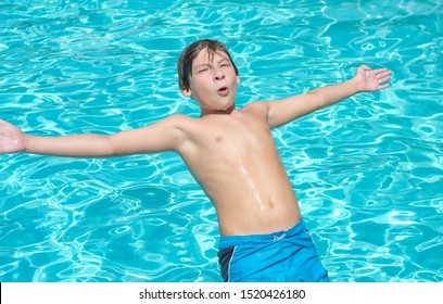 Close Of A Young Handsome Boy Falling Backwards Into A Pool Of Water