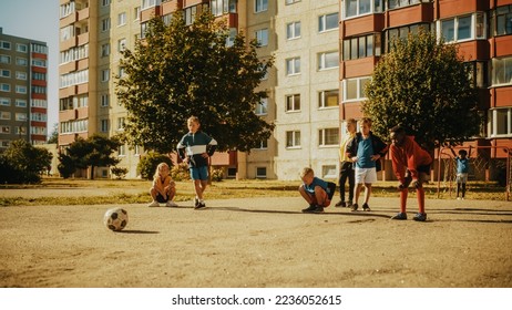 Close Up of a Young Handsome Boy Practising Dribbling with Soccer Ball. Talented Football Player Practicing in the Backyard with His Friends. Low Angle Footage. - Powered by Shutterstock