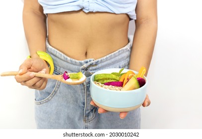 Close Up Of Young Hipster  Woman With Waistline And Eating Yogurt Parfait ,avocado,banana,as Granola Parfait In A Bowl -Banner Diet Plan Concept
