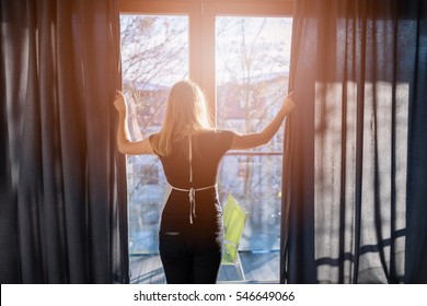 Close Up Of Young Hotel Maid Opening Window Curtains.