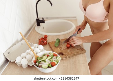 Close Up Of Young Housewife Preparing Salad Cutting Vegetables Standing In Light Kitchen Wearing Pink Underwear. Top View Of Woman In Lingerie Making Breakfast Or Lunch. Food Preparation