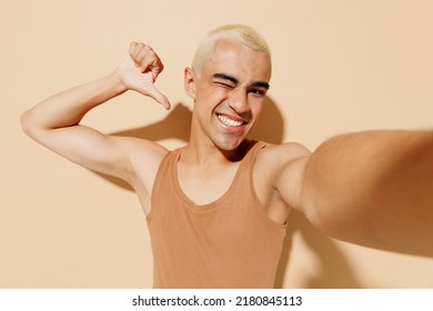 Close Up Young Latin Gay Man With Make Up In Beige Tank Shirt Do Selfie Shot Pov On Mobile Phone Point Finger On Himself Isolated On Plain Light Ocher Background Studio People Lgbt Lifestyle Concept