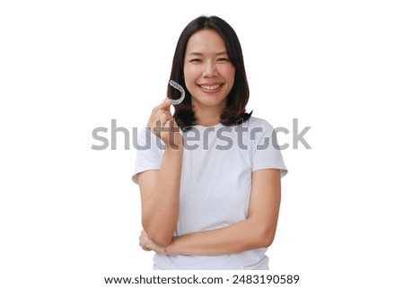 close up young lovely asian woman hand holding dental aligner retainer (invisible) isolated on white background for beautiful teeth content and dental treatment course concept