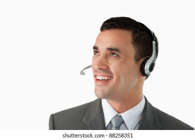 Close up of young male professional with headset on against a white background