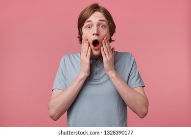 Close Up Of Young Man With Blown Away, Amazed Expression And Dropped Jaw Isolated On Pink Background. Guy Is Shocked Became A Witnessed Of The Accident., Hands Touching Face