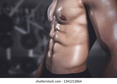 Close Up Of Young Man With Bulging Body Bump Muscle After Workout At Gym Center