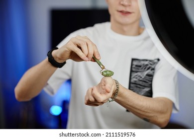 Close Up Of Young Man Demonstrating Beauty Massager While Filming Skincare Tutorial At Home, Copy Space