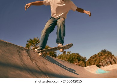 Close up of young man doing tricks on his skateboard at the skate park. Active sport concept - Powered by Shutterstock