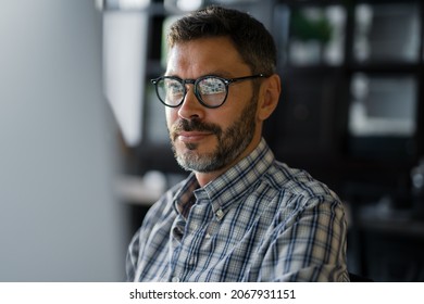 Close Up Young Man in Fashion Glasses Eye Looking Monitor, Surfing Internet. Stylish Male Working With computer From Home in Him Home Office. The Monitor Screen Is Reflected In The Glases
 - Shutterstock ID 2067931151