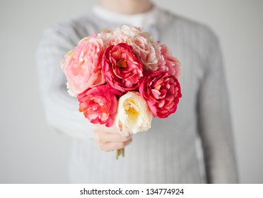 Close Up Of Young Man Giving Bouquet Of Flowers.