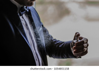 Close Up Of Young Man Groom Use Perfume With Visible Drops