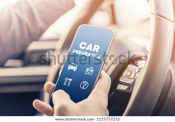 \
close up of young man hand with smartphone driving\
car