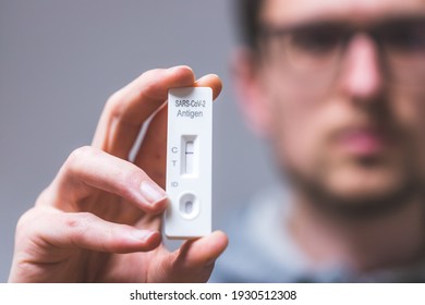 Close up of young man holding express antigen covid test, negative result - Shutterstock ID 1930512308