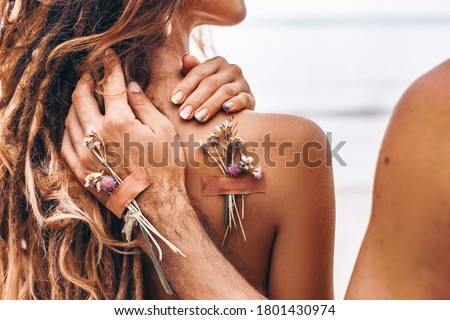 close up of young man holding hand on his woman shoulder