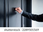 Close up of young man knocking on the door