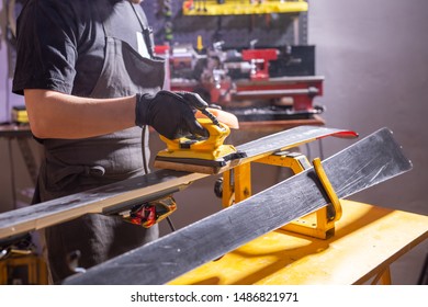 Close Up Of Young Man Repairing The Ski In The Service