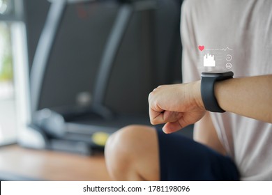  close up young man using smart watch to monitoring about healthcare tracker with virtual display to measure heart rate and calories while workout and rest for technology and futuristic life concept