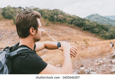 Close up young man's hand using smart watch to used navigation gps and compass for trekking at the mountain path. Technology and trail travel concept. - Powered by Shutterstock