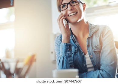 Close up Young Office Woman Talking to Someone on her Mobile Phone While Looking Into the Distance with Happy Facial Expression. - Shutterstock ID 307447607