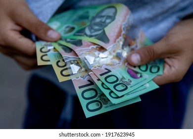 Close up of young person with Australian dollars.