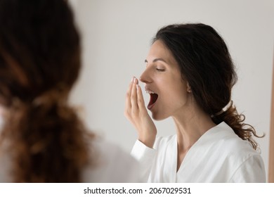 Close Up Young Pretty Woman Wearing Bathrobe Reflected In Mirror Cover Mouth With Palm Checking Breath Freshness After Teeth Cleaning. Teeth-care, Dental Care, Clinic And Mouthwash Products Ad Concept