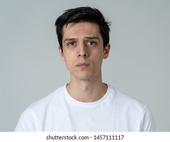 Close Up Of A Young Sad Man, Serious And Concerned, Looking Worried And Thoughtful. Feeling Sorrow And Depression. With Copy Space. In Facial Expressions And Human Emotions Concept.