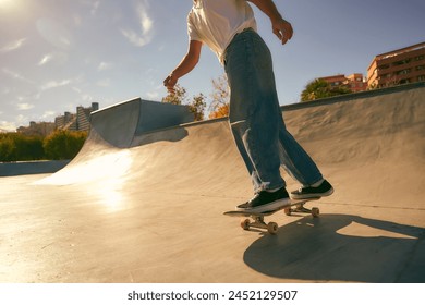 Close up of young skateboarder flies with his board on the ramp of a skate park - Powered by Shutterstock