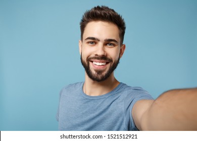 Close up Young smiling man in casual clothes posing isolated on blue wall background, studio portrait. People sincere emotions lifestyle concept. Mock up copy space. Doing selfie shot on mobile phone - Shutterstock ID 1521512921