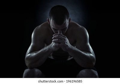 Close up of young sportsman focusing before the game isolated on black background - Powered by Shutterstock