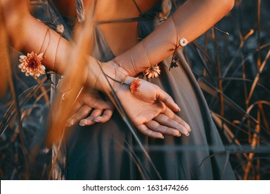 close up of young and tender woman hands crossed behind the back 