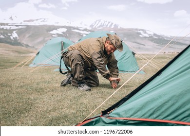 Close up Young Tourist backpacker set up a tent on camping trip. Image of camping,travel,lifestyle or recreation concept. - Shutterstock ID 1196722006