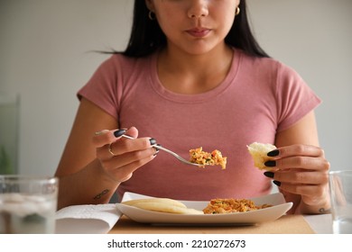 Close Up Of Young Venezuelan Woman Eating Traditional Arepas.