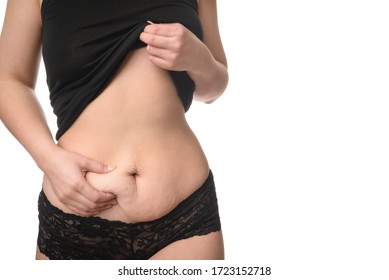 Close Up Of Young Woman Abdomen Showing Loose Skin From Post Partum Belly Fat In Black Underwear