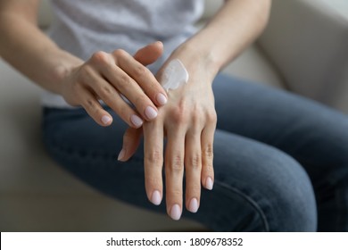 Close Up Young Woman Applying Moisturizing Balm On Hands, Taking Care Of Dry Skin, Making It Healthy And Soft. Lady Enjoying Daily Skincare Spa Procedures, Moisturizing Body Parts With Organic Cream.