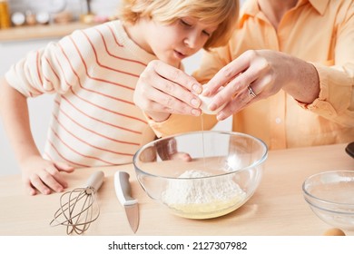 Close Up Young Woman Baking Cupcakes With Cute Little Boy Helping Mother In Kitchen