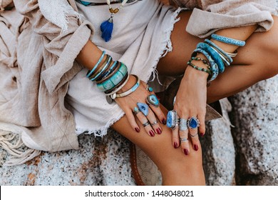 close up of young woman with lot of boho accessories outdoors