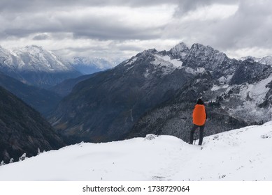 Close Up Of Young Woman Carrying Orange Backpack Stands And Admires The Valley View, She Is On The Way To Sahale Glacier Camp, North Cascades National Park, WA, USA. Concept Of Solo Female Traveler.