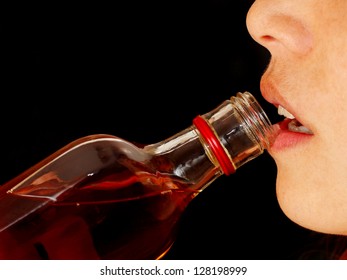 Close Up Of A Young Woman Drinking Hard Liquor From The Bottle