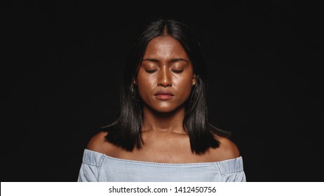 Close up of a young woman with eyes closed isolated on black background. Portrait of a woman with closed eyes. - Powered by Shutterstock