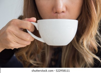 Close Up Young Woman Hands Drinking Morning Hot Coffee Mug In Cafe. Tea Break Time. Enjoy Smelling Inhales Sipping Tea.
Young Girl Holding Warm Cup Of Brewed Tea. People Drinking Lifestyle Concept.