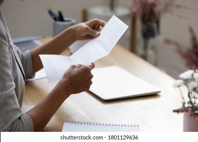 Close Up Young Woman Holding Paper Letter With Good News, Getting Banking Loan Approval. Millennial Businesswoman Received Correspondence, Reading Fashion Show Or Special Event Invitation Indoors.