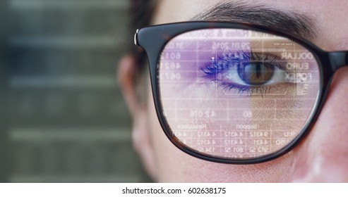 Close up of young woman on career with blue eyes wearing the glasses looking on the waveform lines expressed concept of stock market,augmented reality, technology, stock exchange  and finance