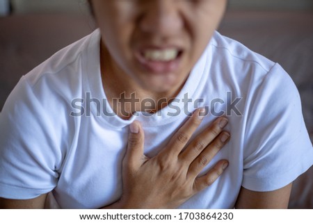 Close up Young woman suffering from chest pain, chest pain concept
