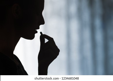 Close Up Of Young Woman Taking Prescription Pill. Medicine, Health Care Concept.