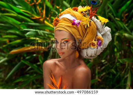close up of young woman in turban with flowers