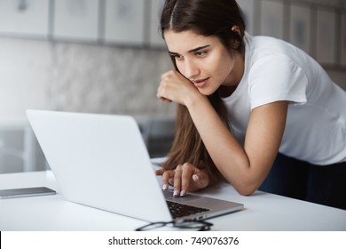 Close Up Of Young Woman Using A Laptop Computer To Apply For A Job Online.